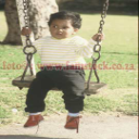 k6128- very non-smiling boy toddler on swing in bright sunlight